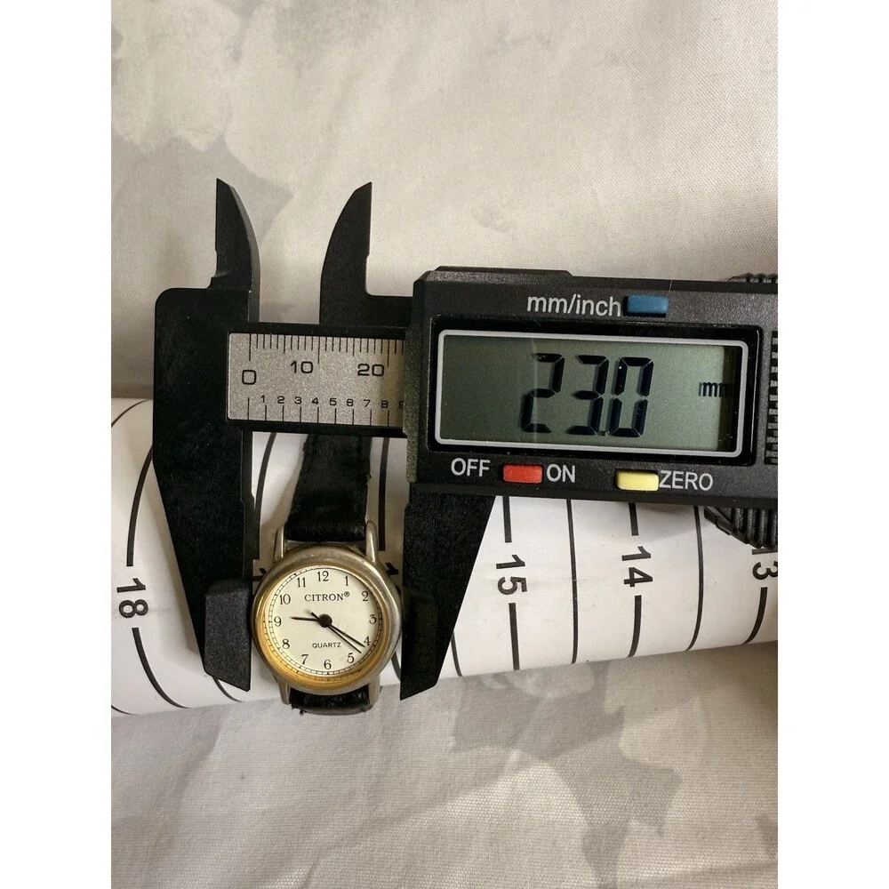 Citron Vintage Women’s Watch, White dial and gold casing. Black leather band.